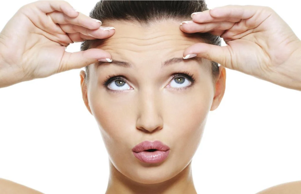 Woman showing forehead lines that anti-wrinkle treatment can soften