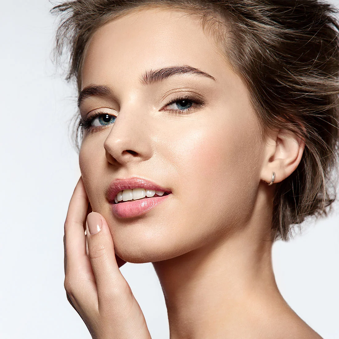 Woman with fresh, natural, healthy skin after facial aesthetics